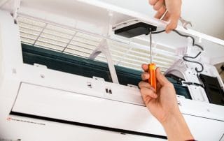 Service man is cleaning, repair and maintenance of air conditioner